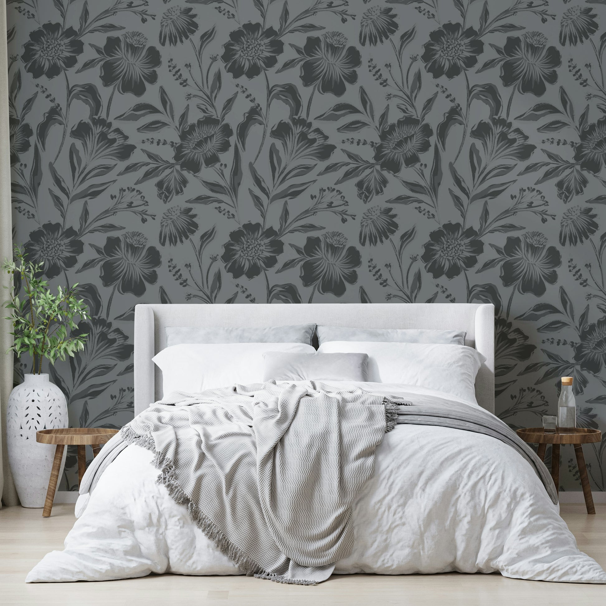 The image features large flowers and leaves depicted as soft silhouettes.
