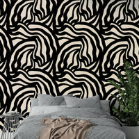 A bedroom wall featuring the wavy black lines mural, giving a calm and artistic feel