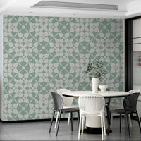 An installation view of the wallpaper being hung on a wall.

