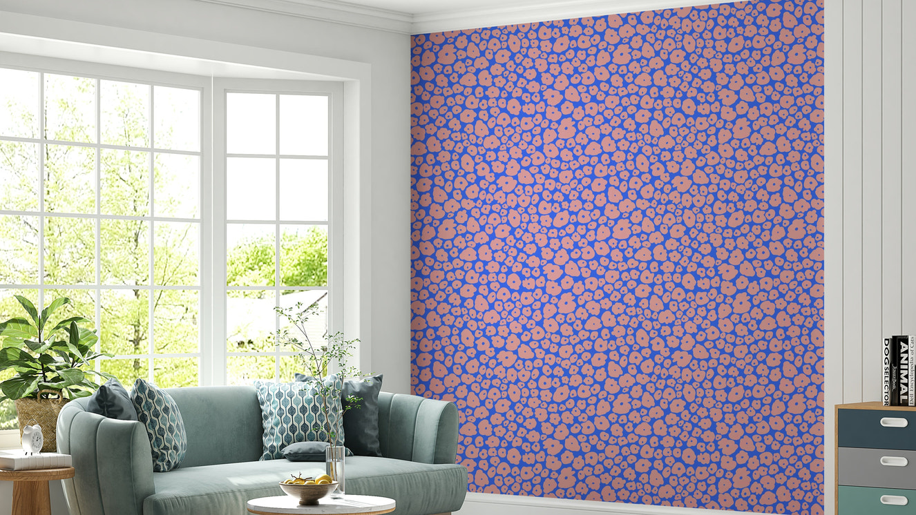 An installation view of the wallpaper being hung on a wall.

