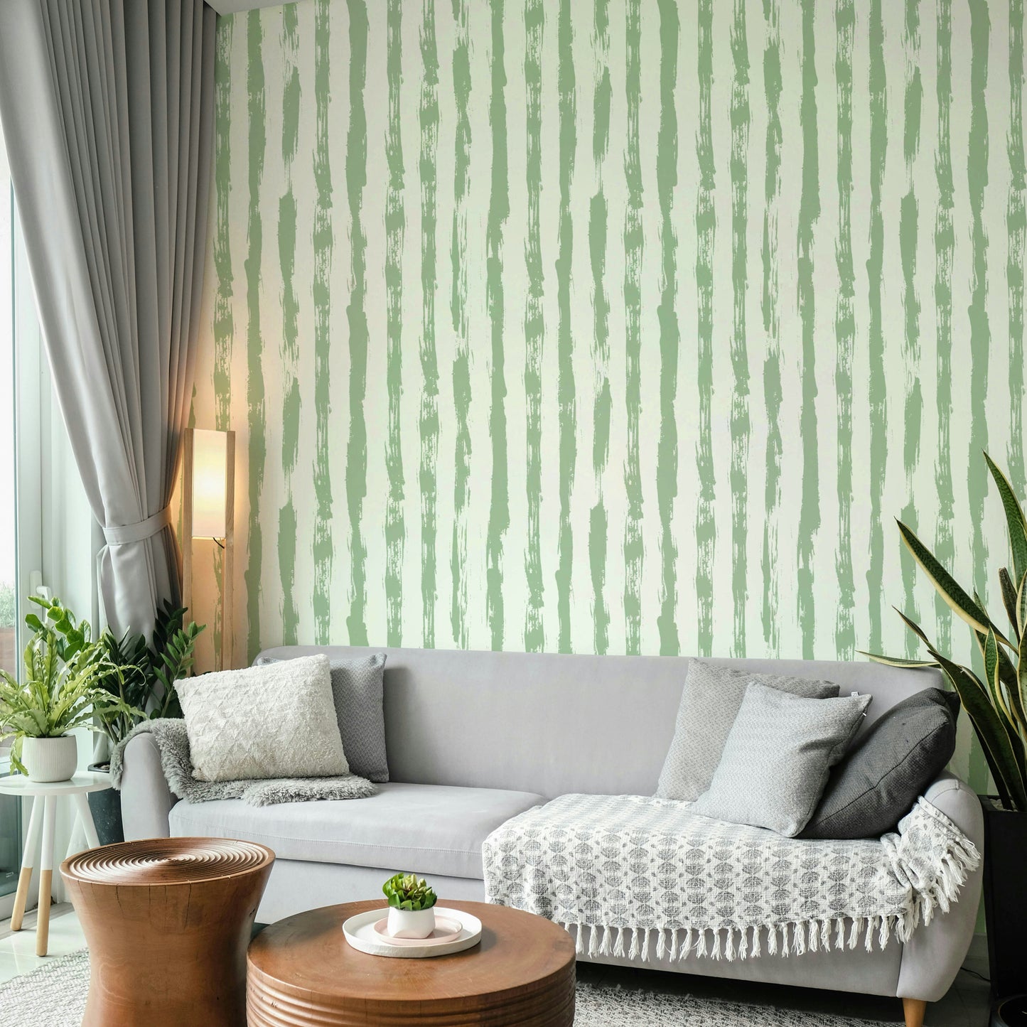 A living room with a simple sage green stripe design

