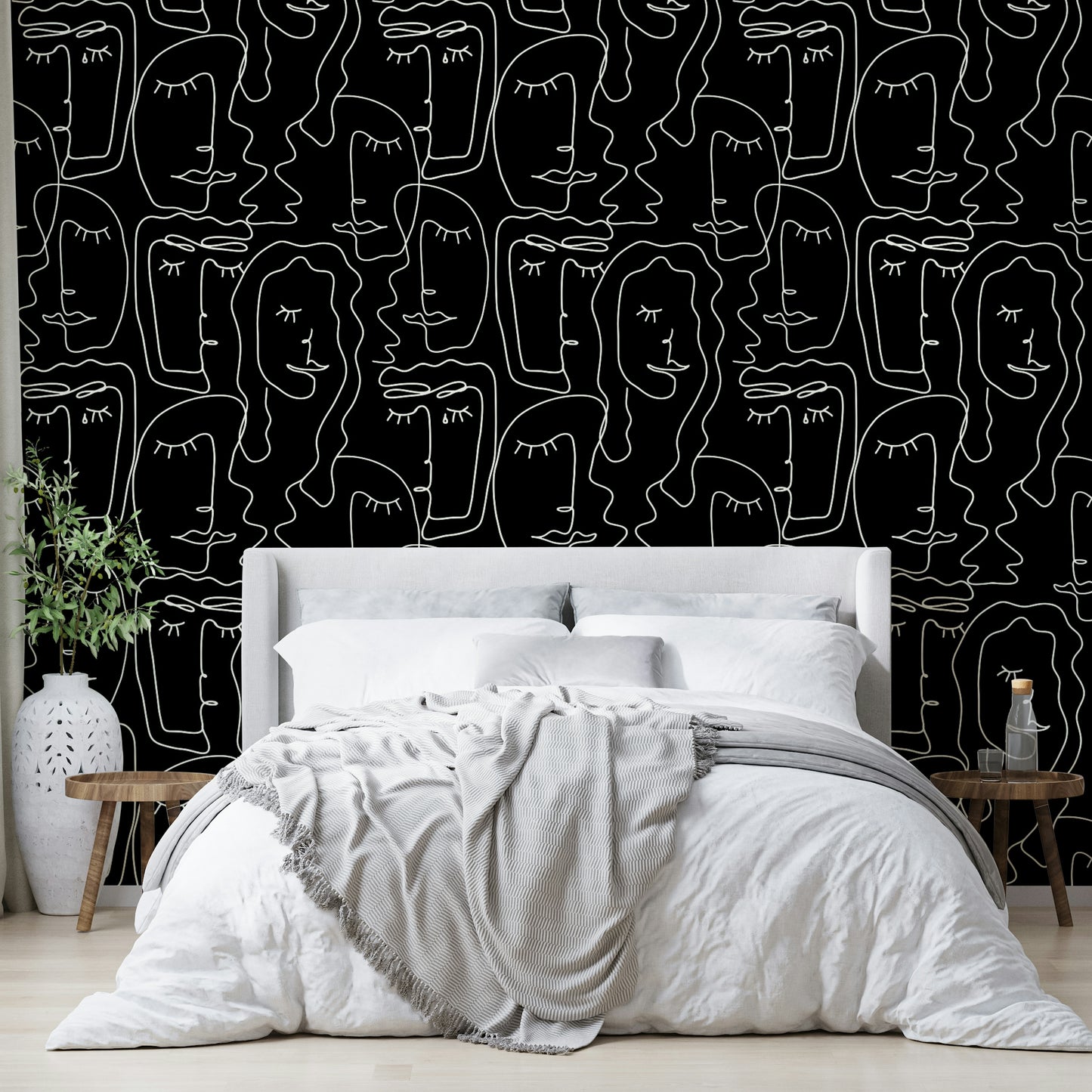 An angled shot of a wall with face outline wallpaper

