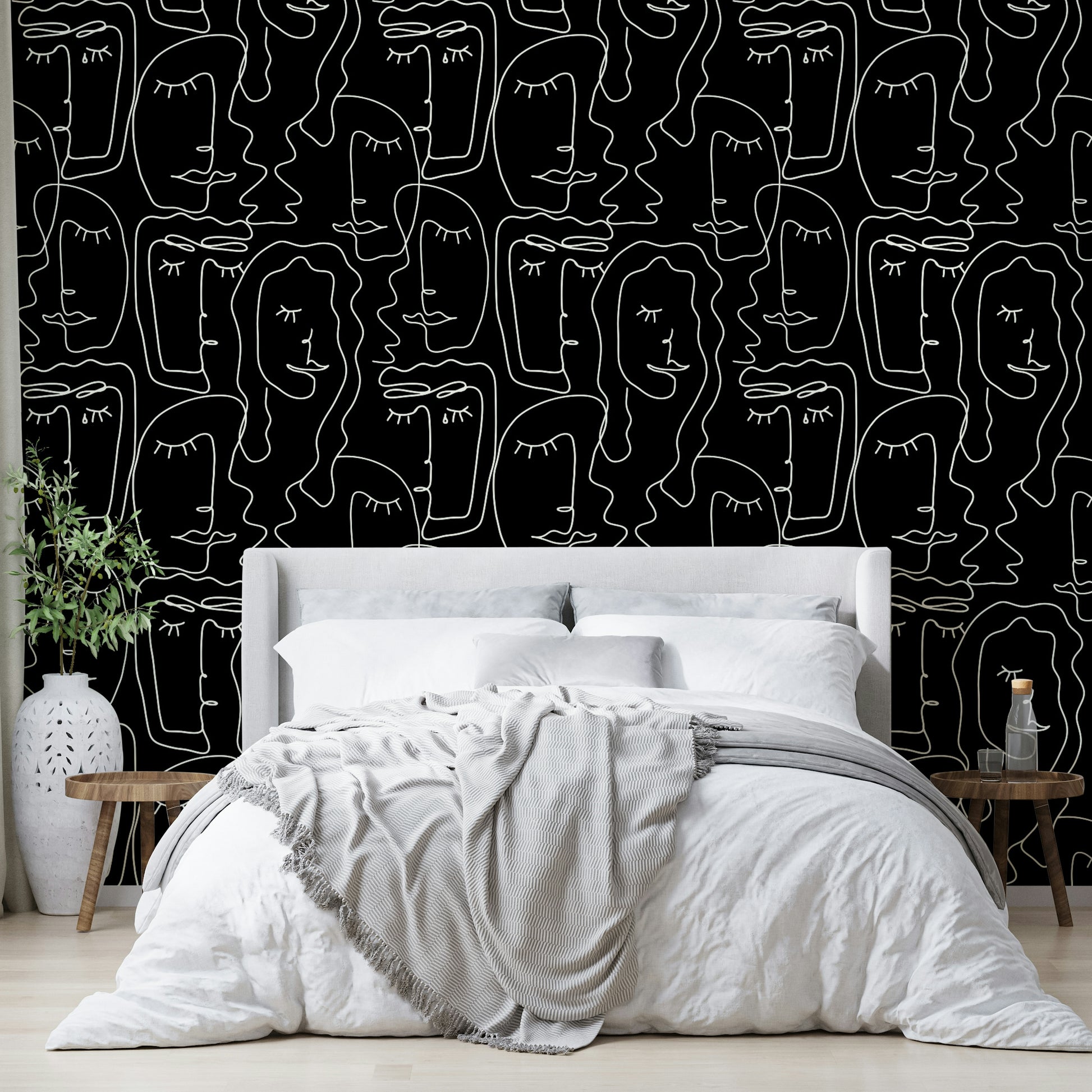 An angled shot of a wall with face outline wallpaper

