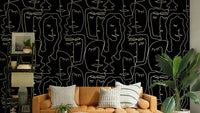 Outline faces wallpaper on a living room wall

