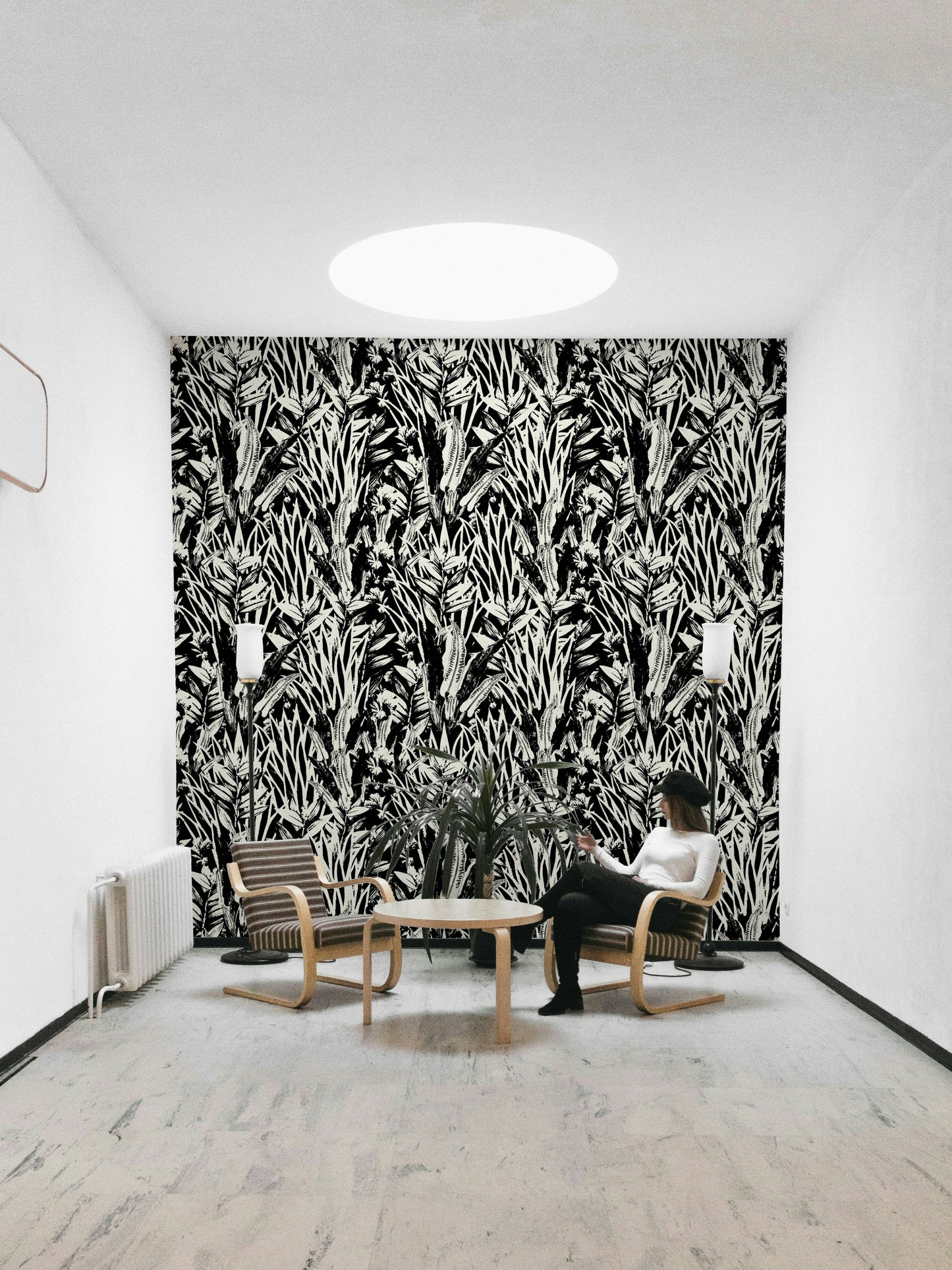 Monochrome leaves wallpaper on a living room wall

