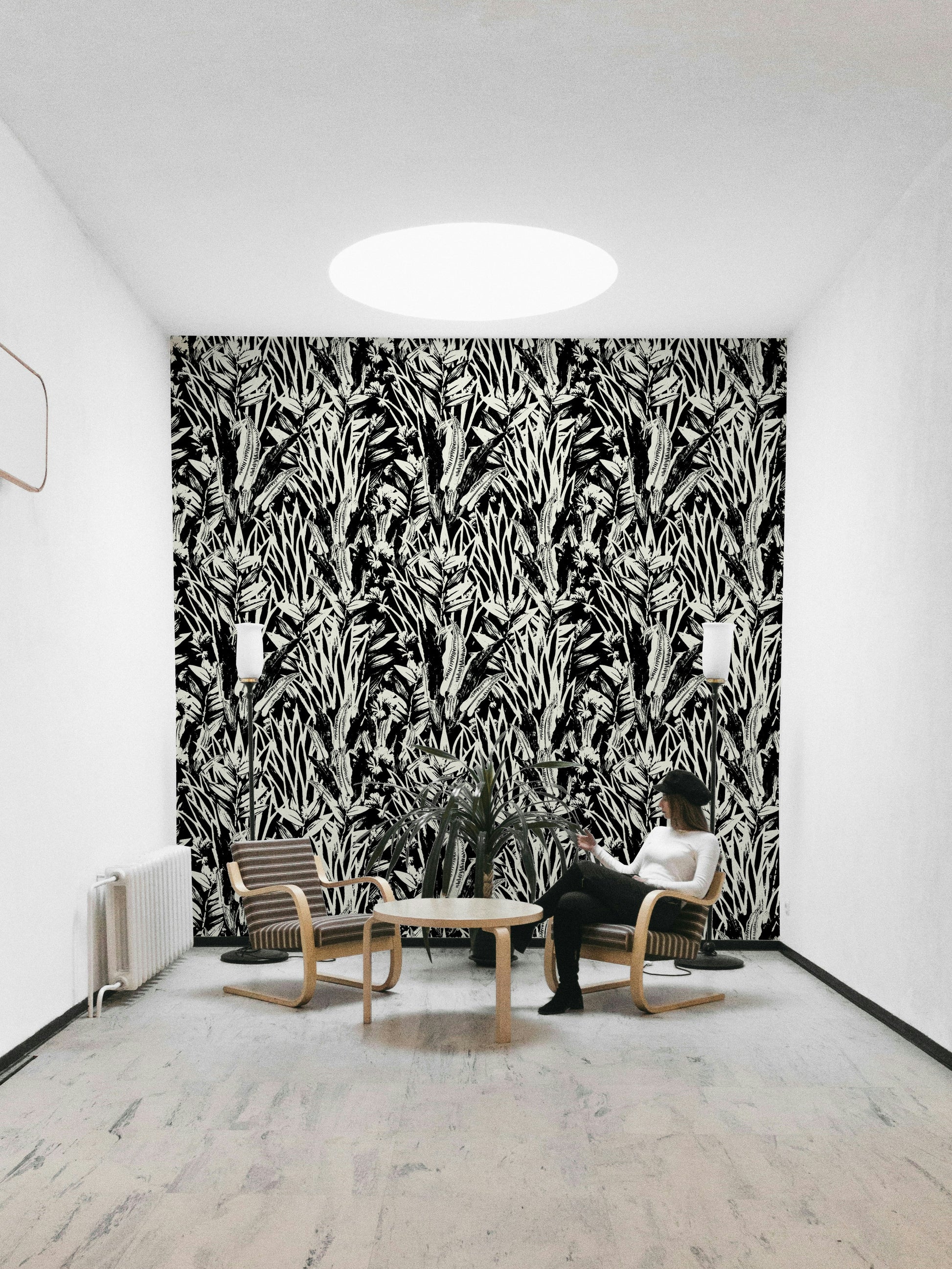 Monochrome leaves wallpaper on a living room wall

