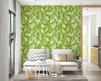 An angled shot of a wall with green leaf wallpaper

