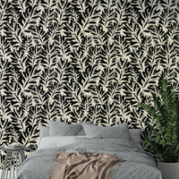 A living room decorated with a painted leaf mural

