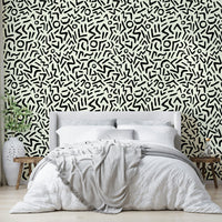 Hand drawn abstract tribal wallpaper on a living room wall

