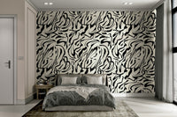 A bedroom with the artistic mural behind the headboard.

