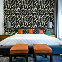 A bedroom with the minimalist mural behind the headboard.

