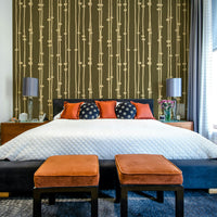 A bedroom with the striped mural behind the headboard.

