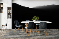 The wallpaper is used to create a feature wall in a dining room.