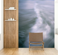 The wallpaper is used to create a feature wall in a dining room.