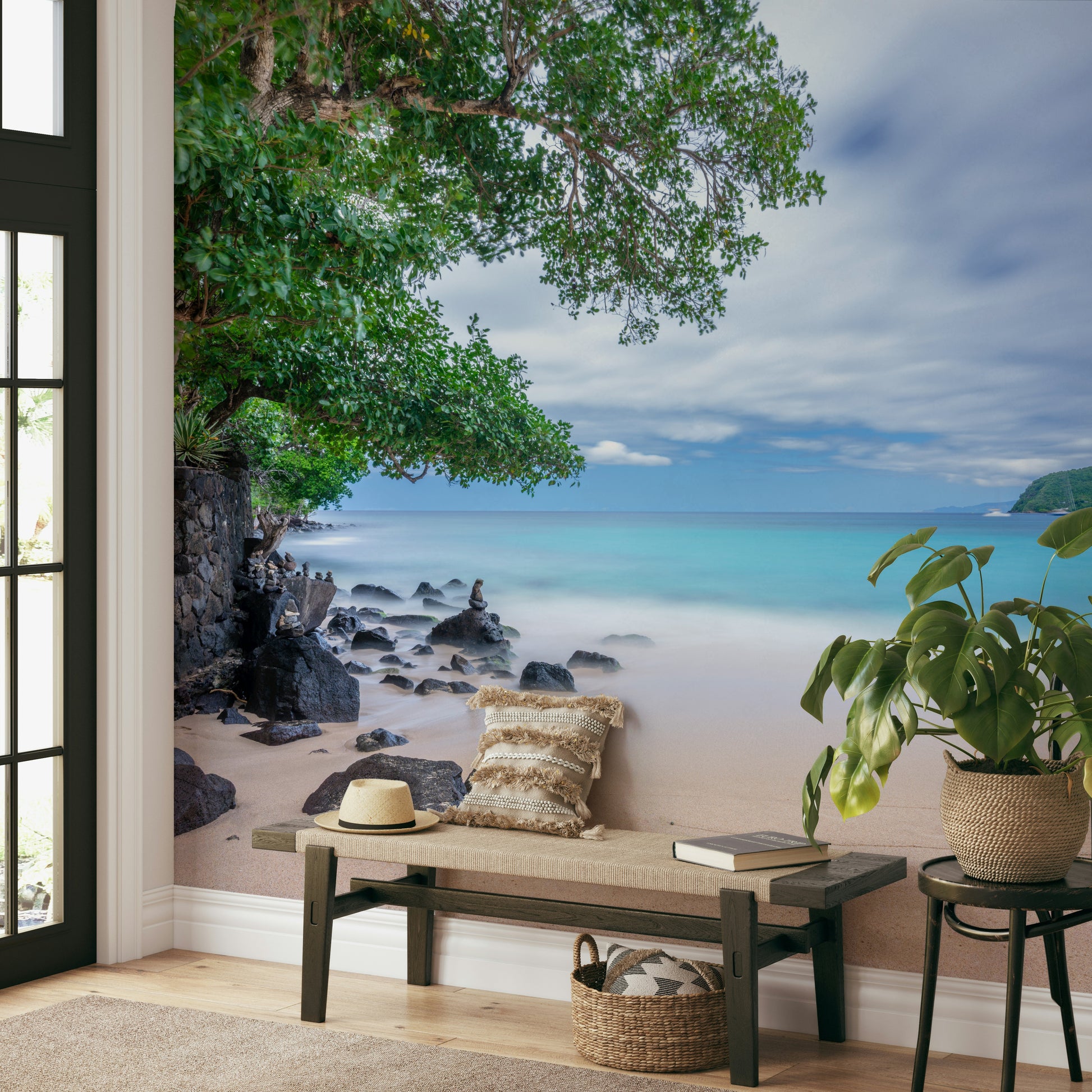 A graceful tropical shoreline wall mural with black rocks.

