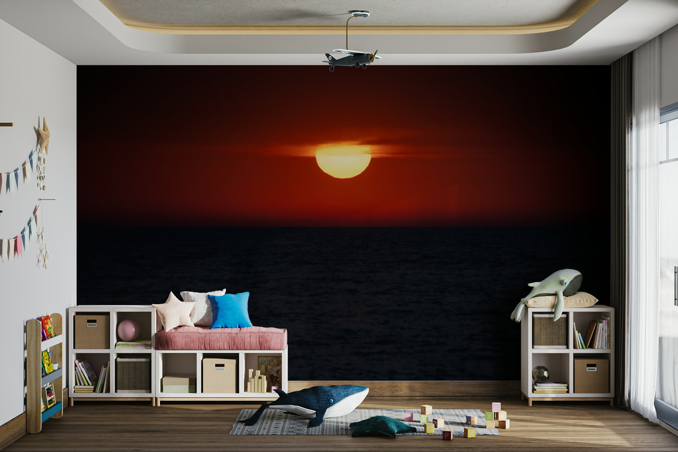 A beautiful dramatic sunset over the ocean wallpaper mural.


