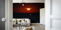 An artistic ocean sunset mural on minimalist wallpaper.

