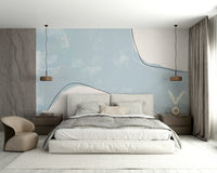 An artistic soft blue stroke mural on minimalist wallpaper.

