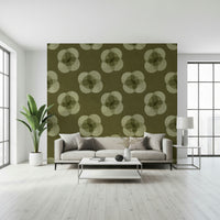 A graceful subtle bloom wall mural in soft, olive tones.
