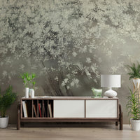 A peaceful tree and flower mural on decorative wallpaper.