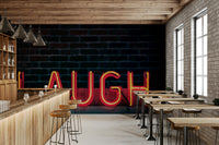 A beautiful neon glow wallpaper mural with a 'Laugh' script and bold, vibrant colors.