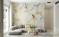 A beautiful subtle gilded marble wallpaper mural with fluid, swirling veins and gold accents.