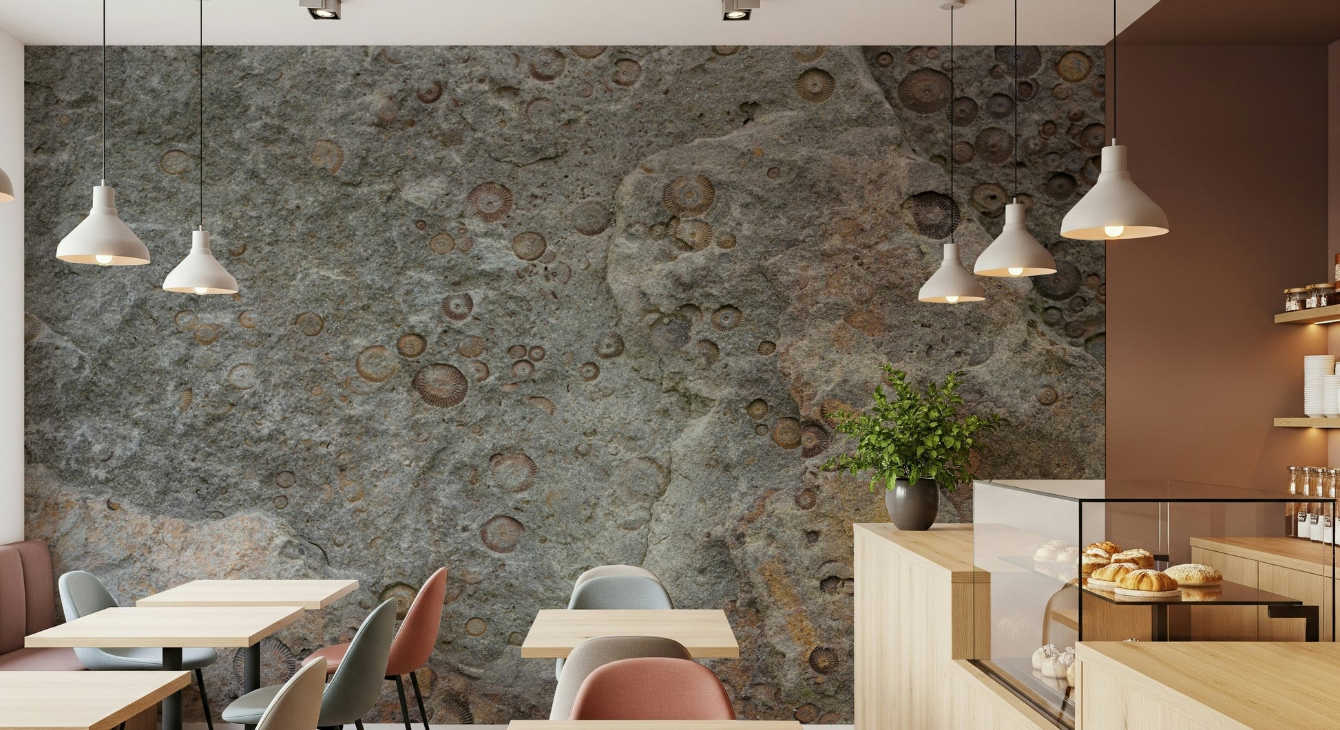 Grey sofa against a stone fossil texture wall mural.