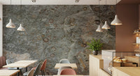 Grey sofa against a stone fossil texture wall mural.