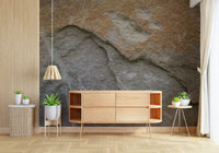 Surface detail of the eroded rock face mural.