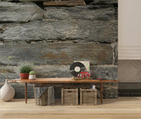 Aged stone wall mural in a modern living room.