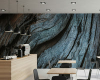A home office accent wall with the textured blue wood peel and stick mural.