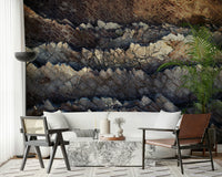 Stratified stone wall mural in a rugged living room.