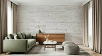 Gray sofa styled against the Bright Stacked Stone mural.