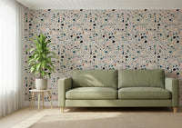 Abstract geometric speckled pattern of vibrant multicolour terrazzo mural design.