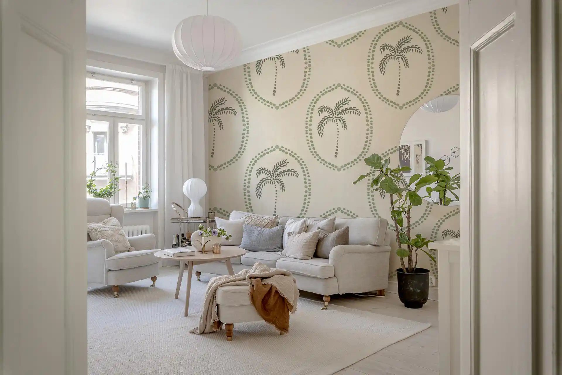 Living room calmer behind soft sage motifs from Beachy Boho Palm Coastal Green Medallion wallpaper., GD9631