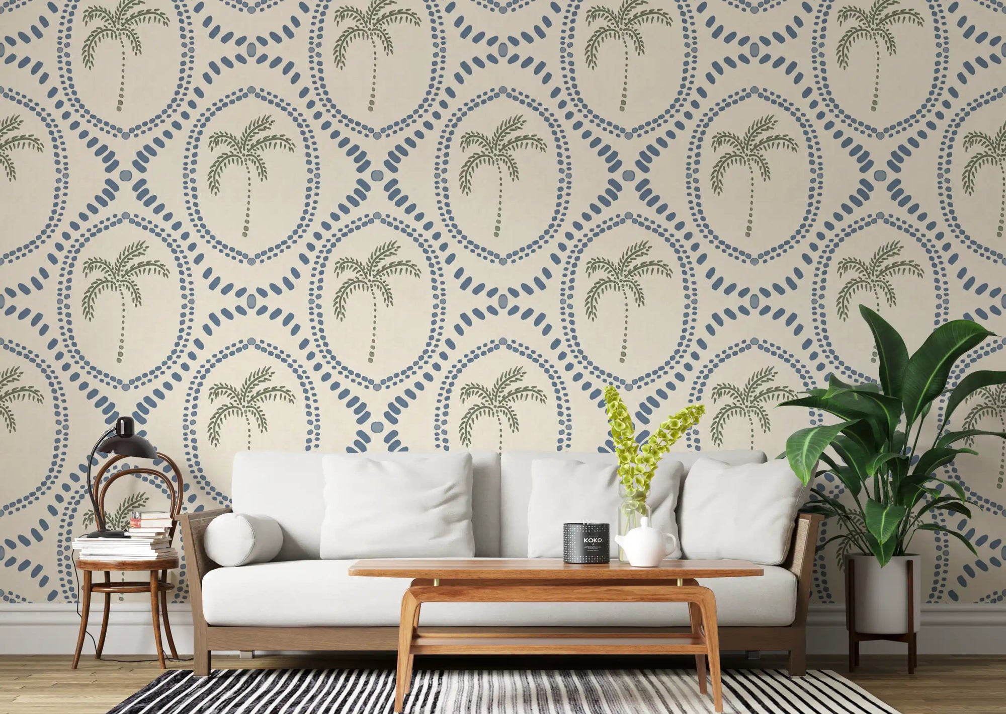 Cool slate blue medallions stretch across the living room behind this Beachy Boho Palm Oasis wallpaper., GD9635