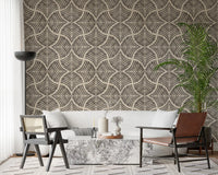 Textured scallops fan motifs dramatize a living room in dark brown Japandi wallpaper.