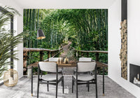 Tall bamboo stalks line both sides of a winding path on this serene wall mural.