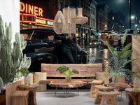 Neon diner signs glow over a wet cobblestone street in this noir wall mural.