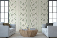 Easy coastal vibes wash a lounge with sage palm motifs across this wallpaper.