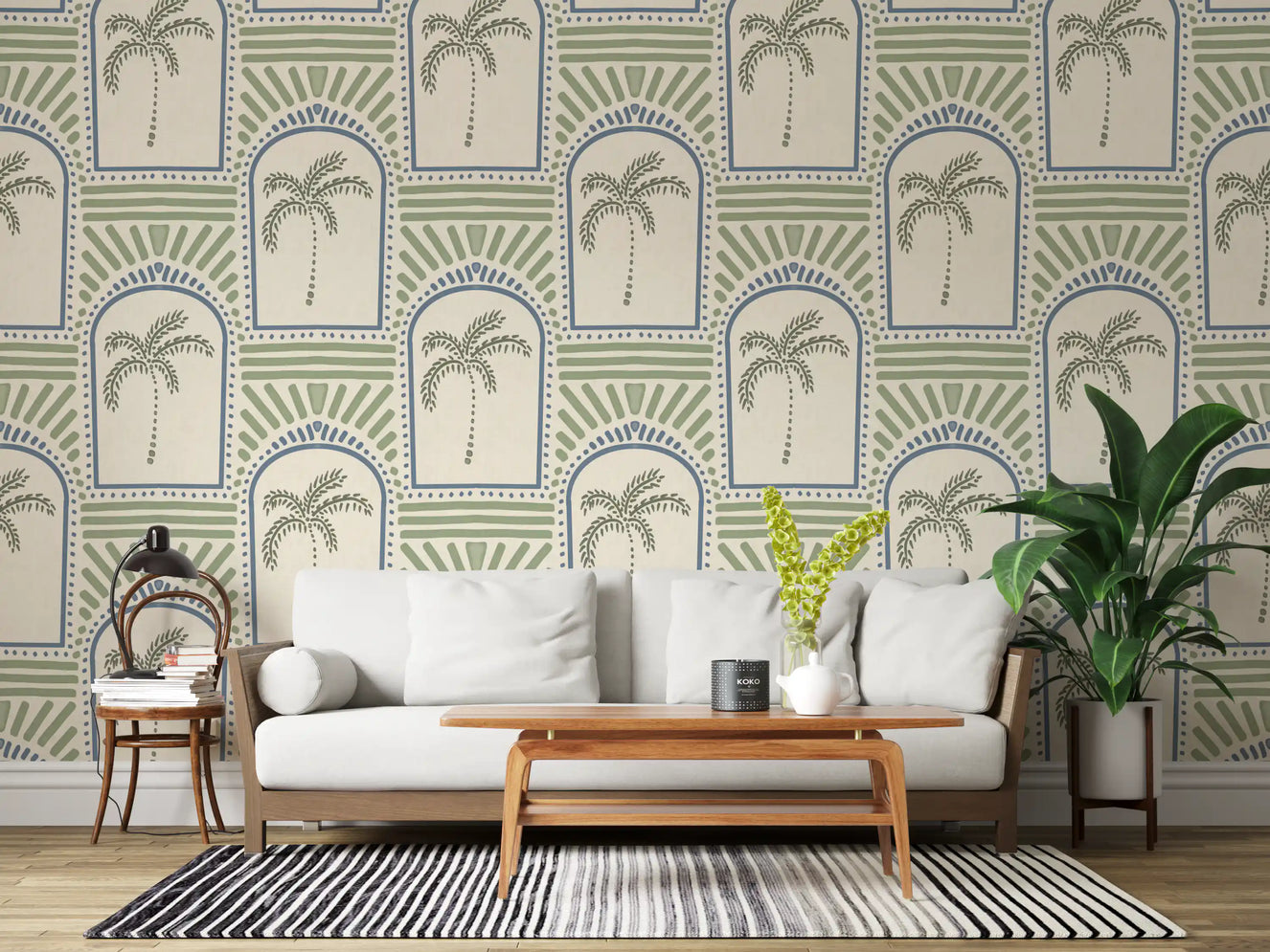 Palm archway wallpaper centering a wide living room in slate blue arches and sage palms.