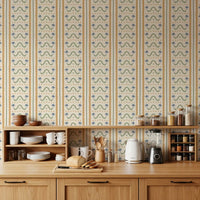 Marrakesh striped wallpaper behind a warm kitchen-dining setup, palm motifs visible.