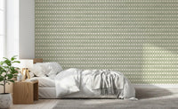 Sage-green ornament rows alternate in this zellige cross wallpaper, cream linen visible., GD9667
