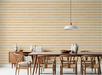 Warm dining room view backed by sand zellige cross wallpaper across rows.