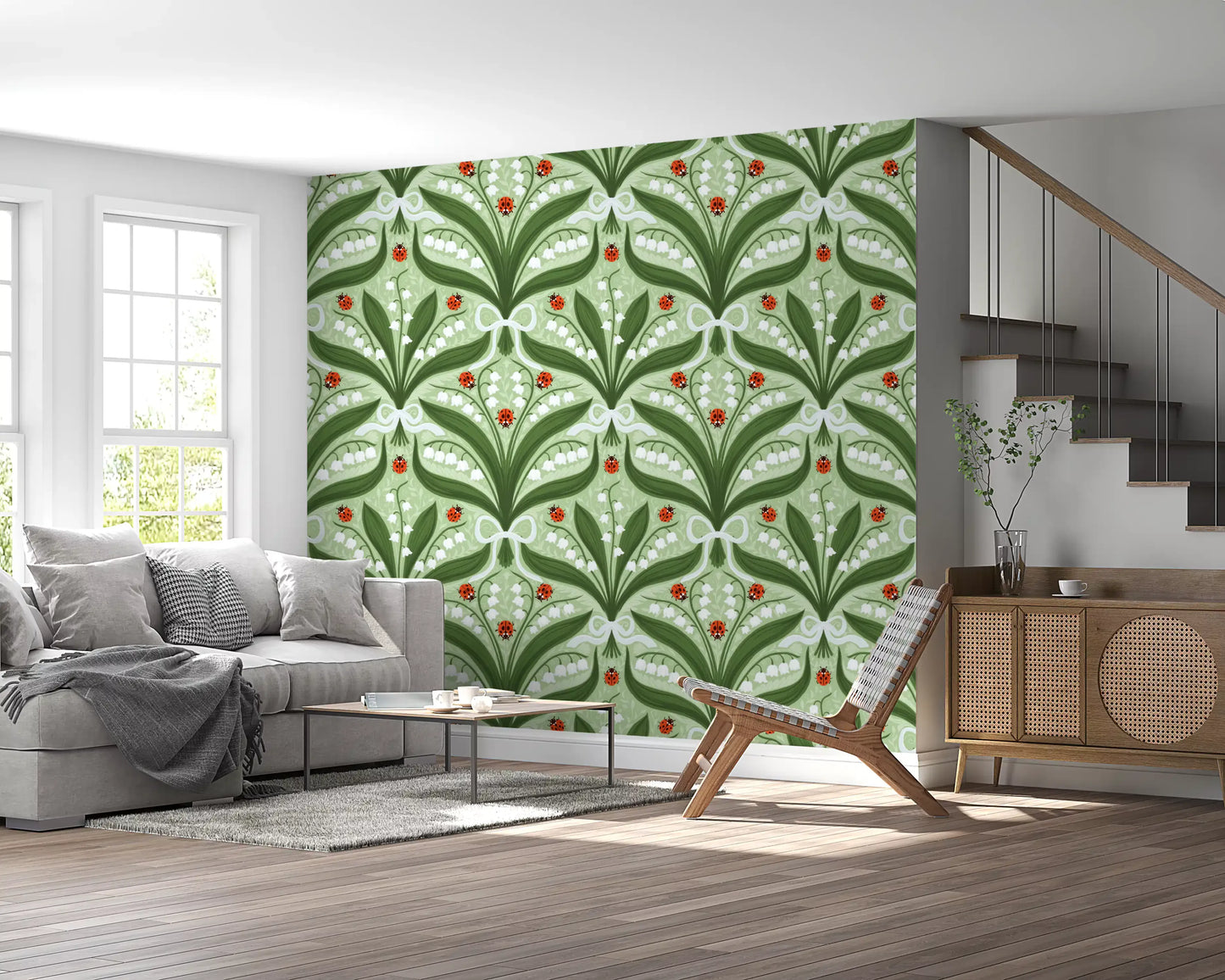 Three red ladybugs sit at the heart of every panel of this lily of the valley wallpaper.