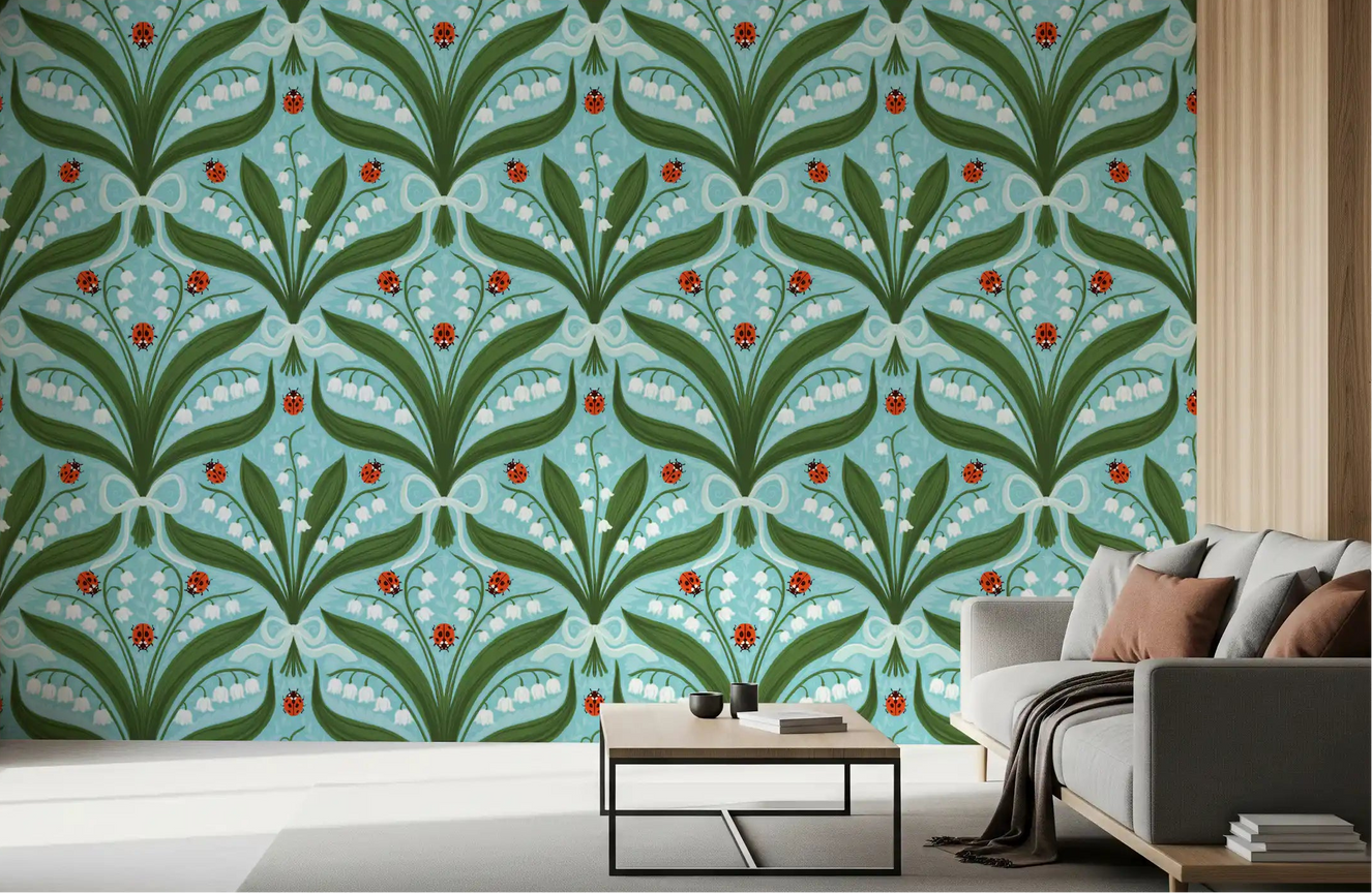 Blue and green tones lift a relaxed living room behind this lily of the valley wallpaper.