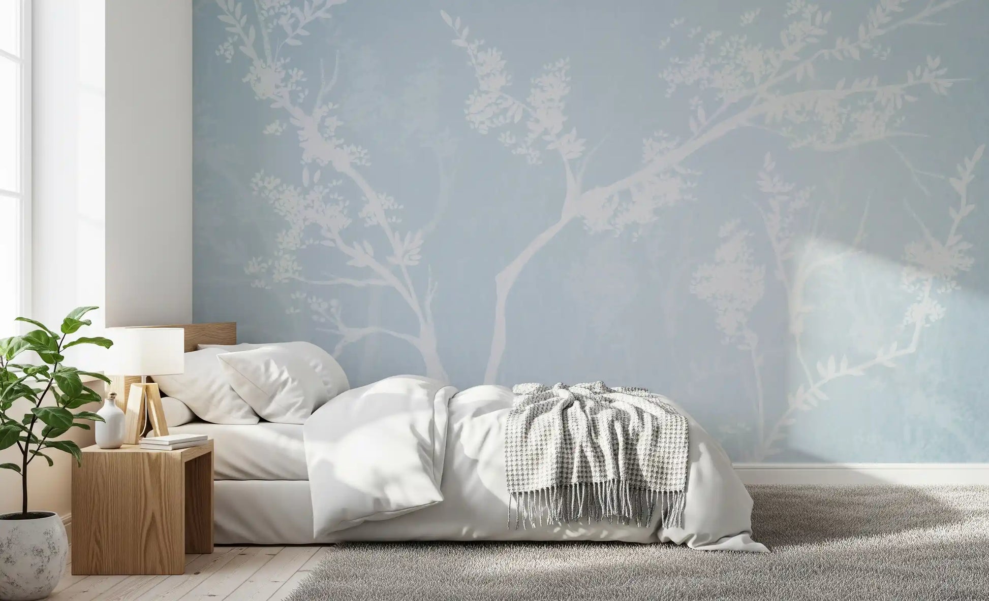 White blossom and branch silhouettes on the Ethereal Blue wall mural
