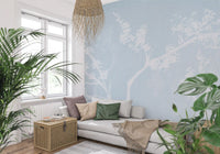 Powder blue background with white blossom tree silhouettes on this wall mural