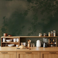 Dark olive branches rise through grey mist in the Verdant Mist wall mural