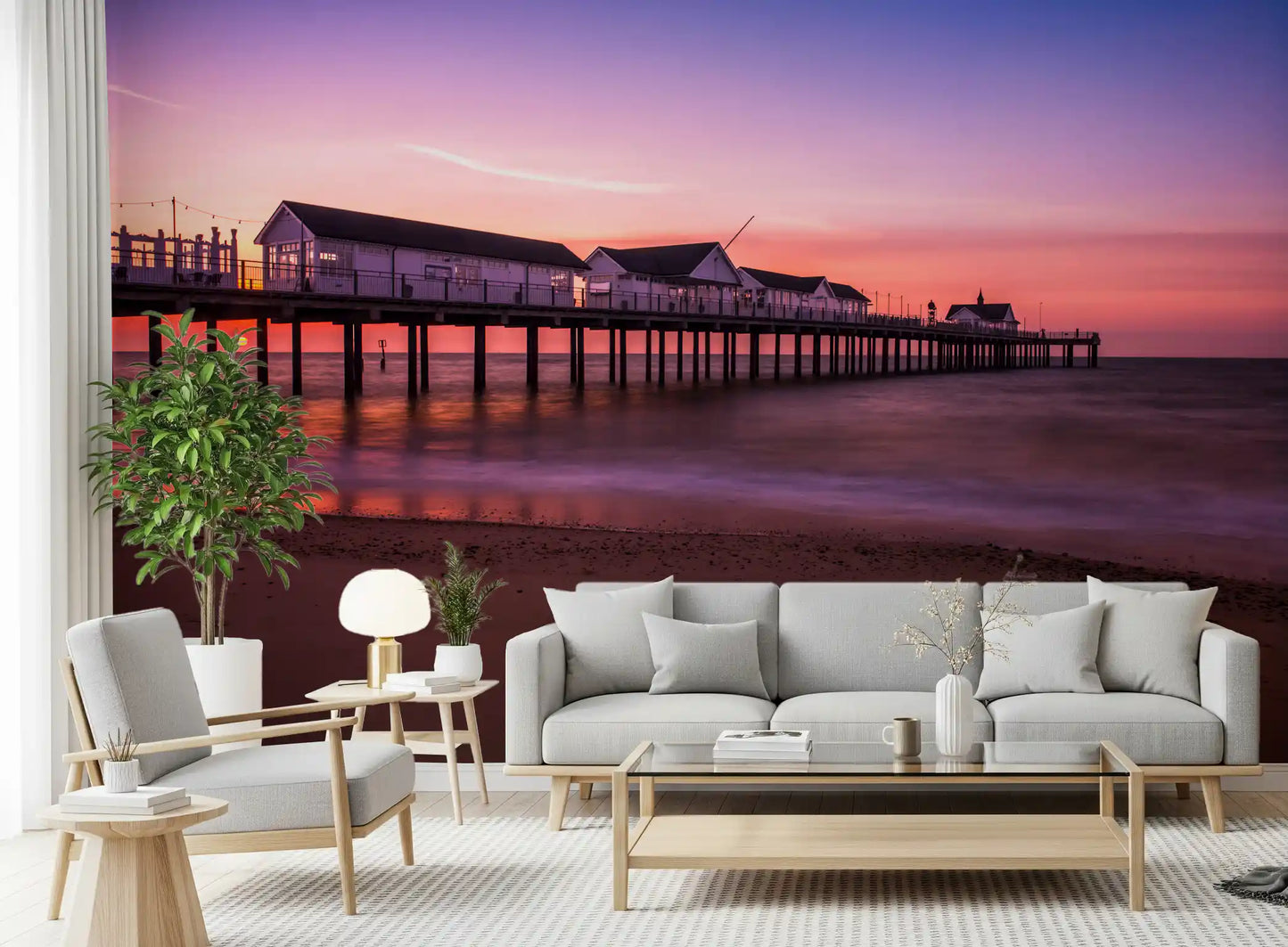 Living room with sunset pier reverie wall mural calm ocean backdrop

